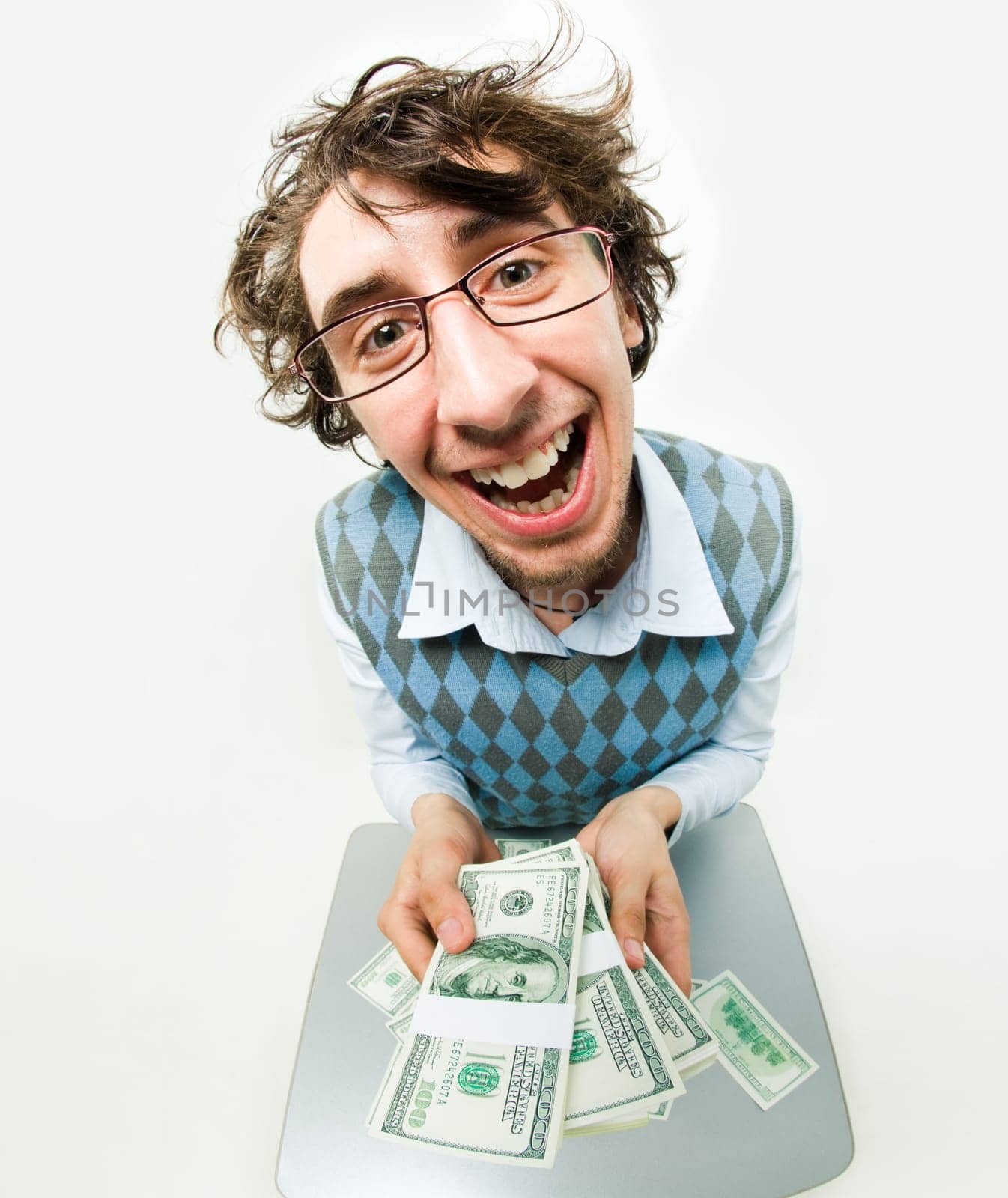 Fish-eye shot of happy young man holding several packs of dollars and smiling