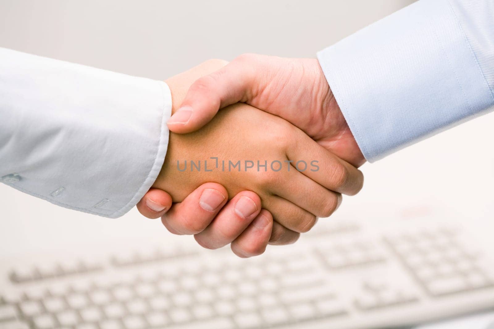 Photo of handshake of business partners after striking deal