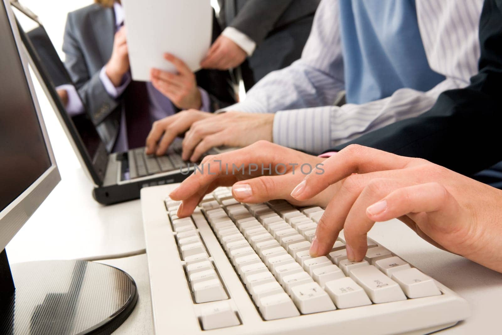 Photo of females hands touching keys of board during briefing on background of human hands