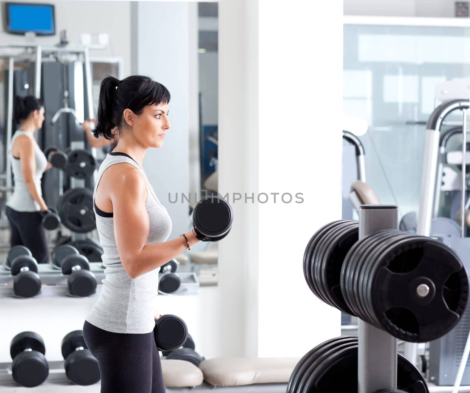 woman with weight training equipment on sport gym club