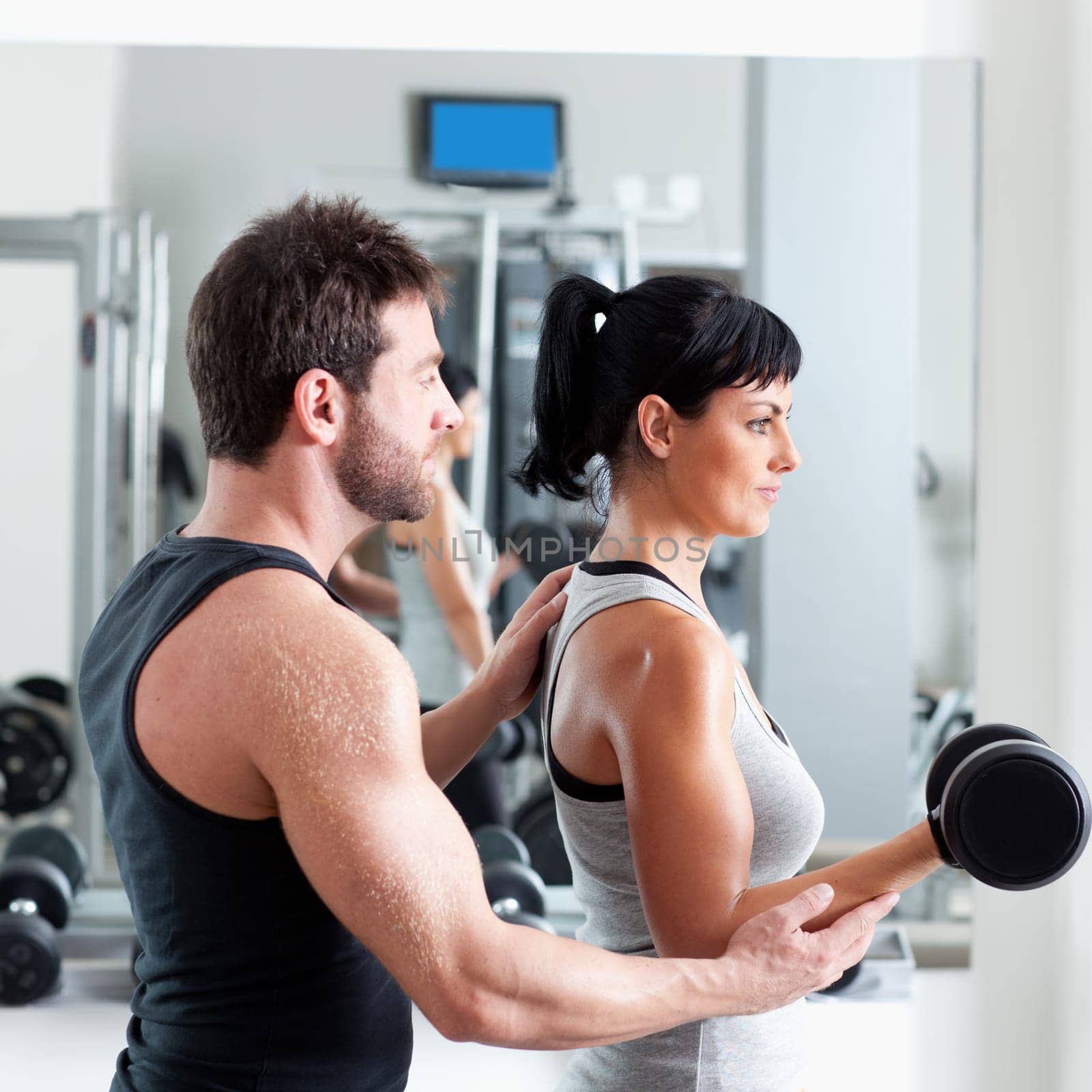 gym woman personal trainer man with weight training equipment