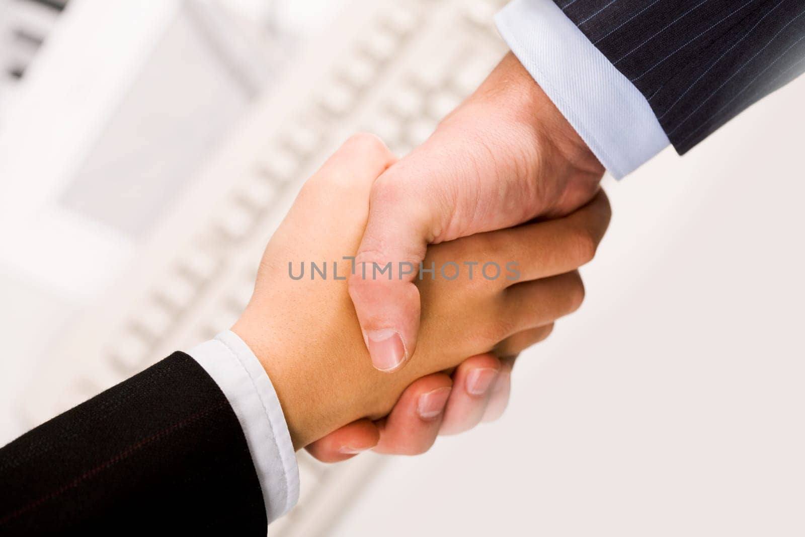 Photo of handshake of business partners after signing promising contract