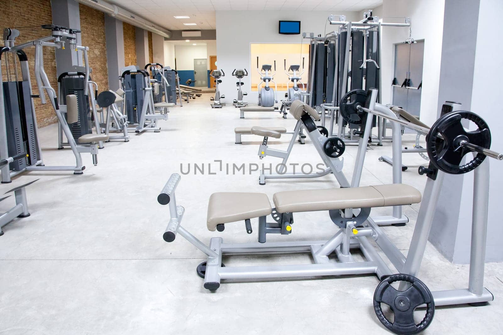 Fitness club gym with sport equipment modern interior