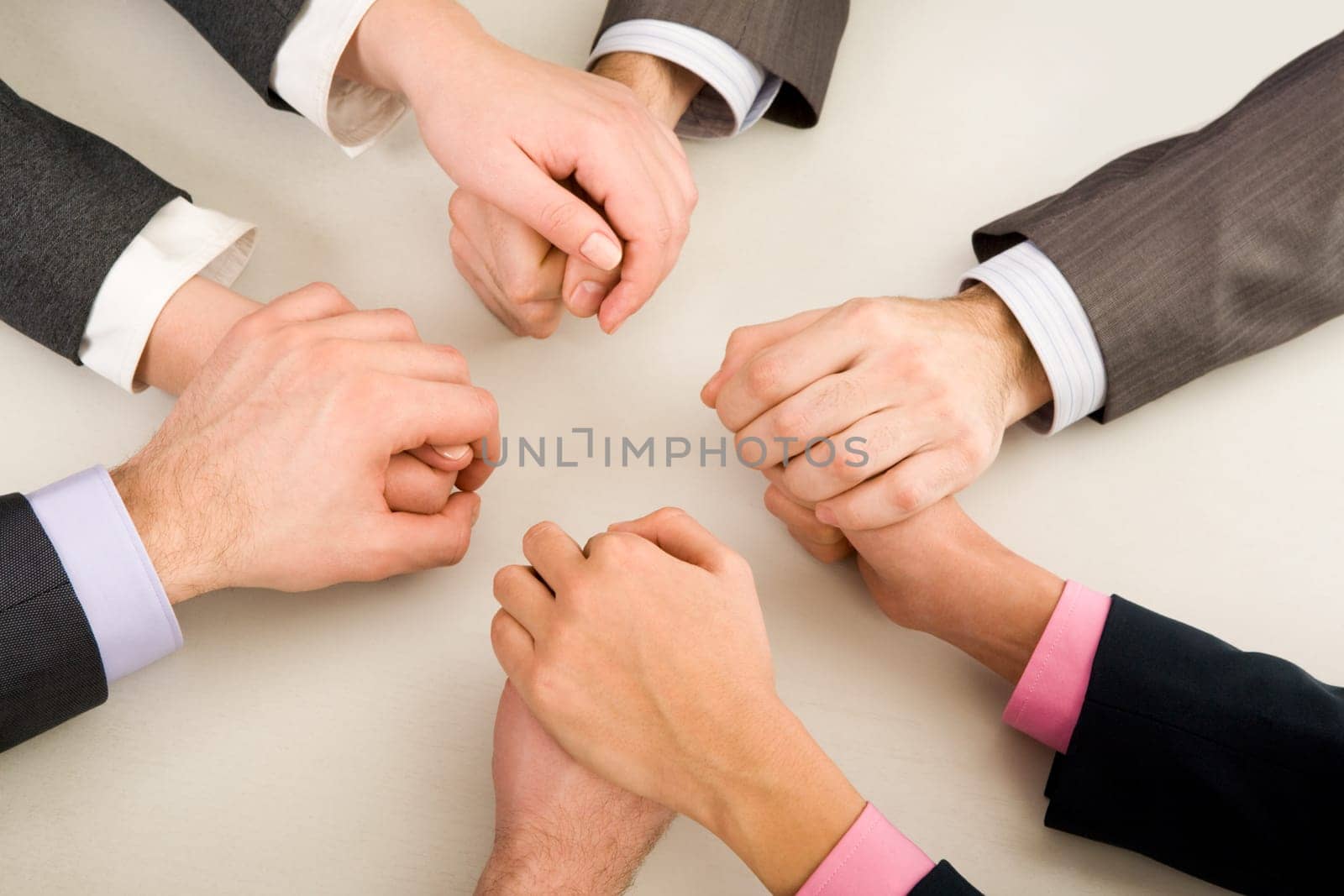 Image of business partners hands holding each other