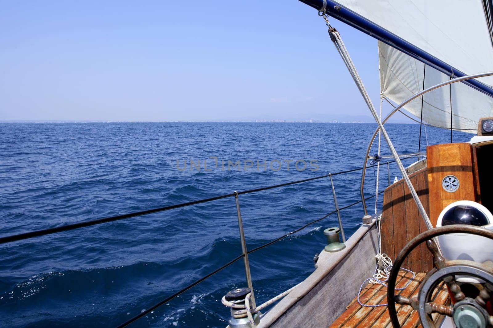 Sailing with an old sailboat over blue mediterranean summer sea
