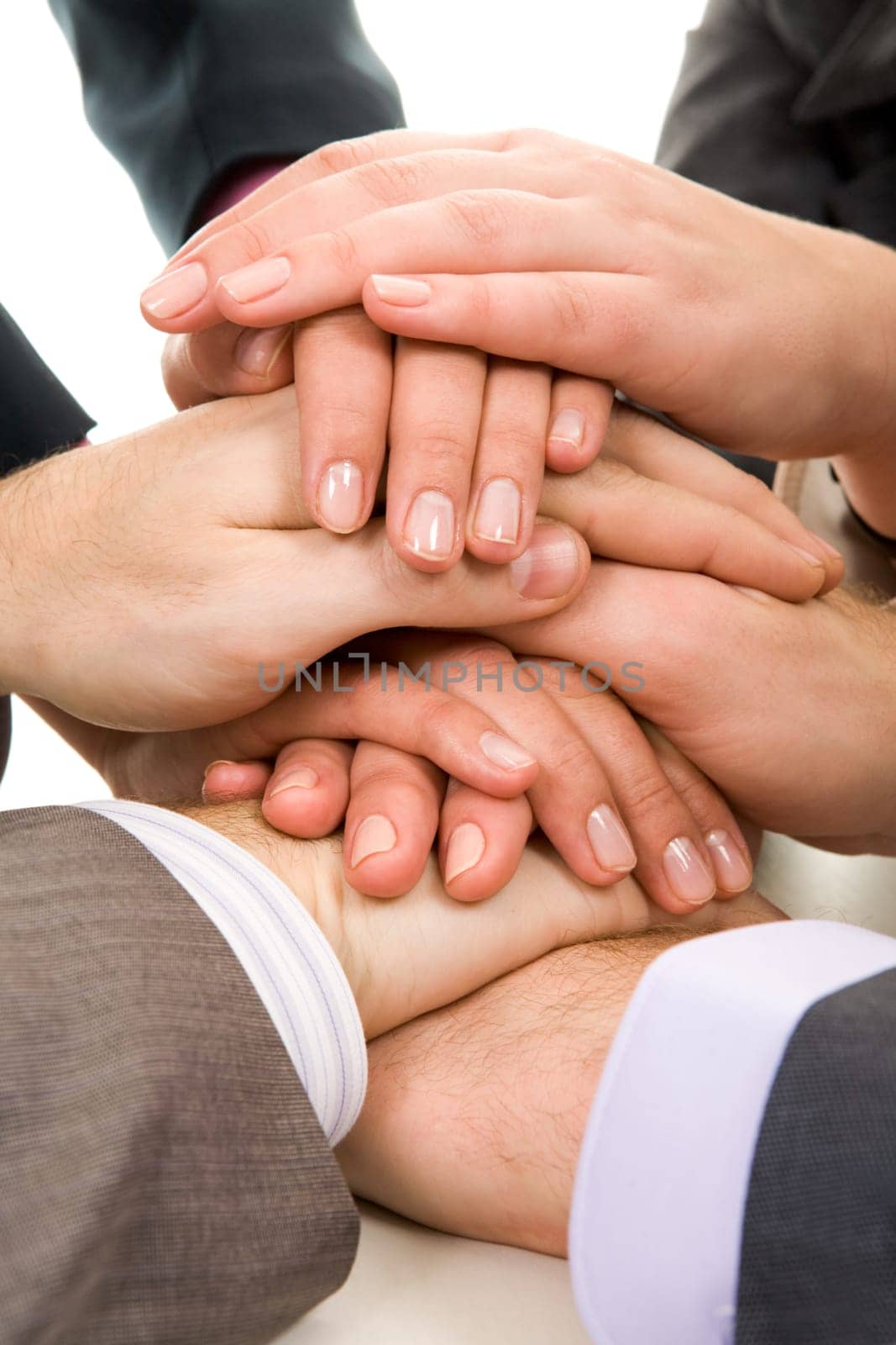 Image of business people hands on top of each other symbolizing support and power