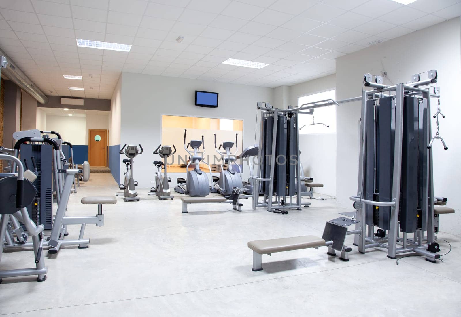 Fitness club gym with sport equipment modern interior