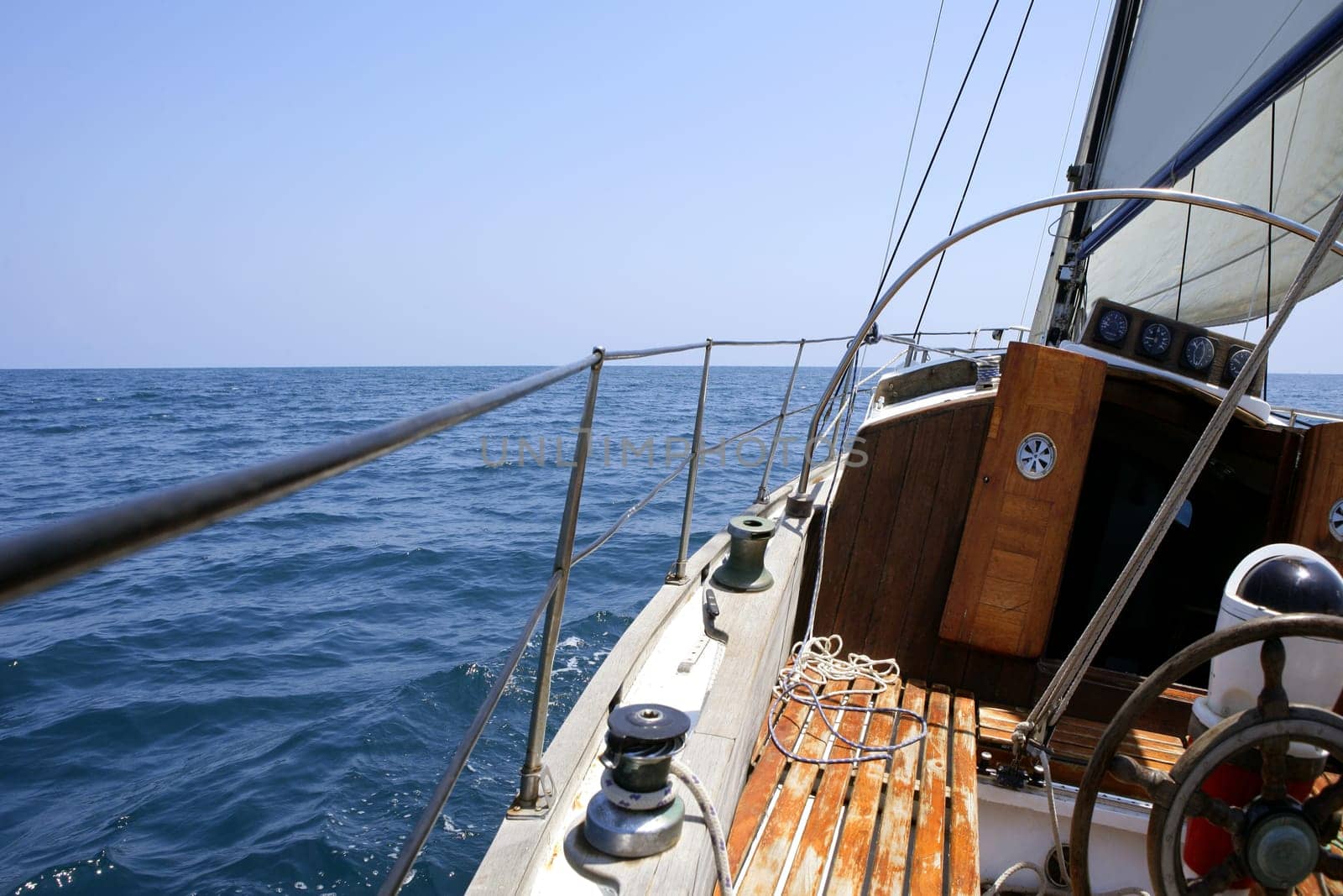 Sailing with an old sailboat over blue mediterranean summer sea