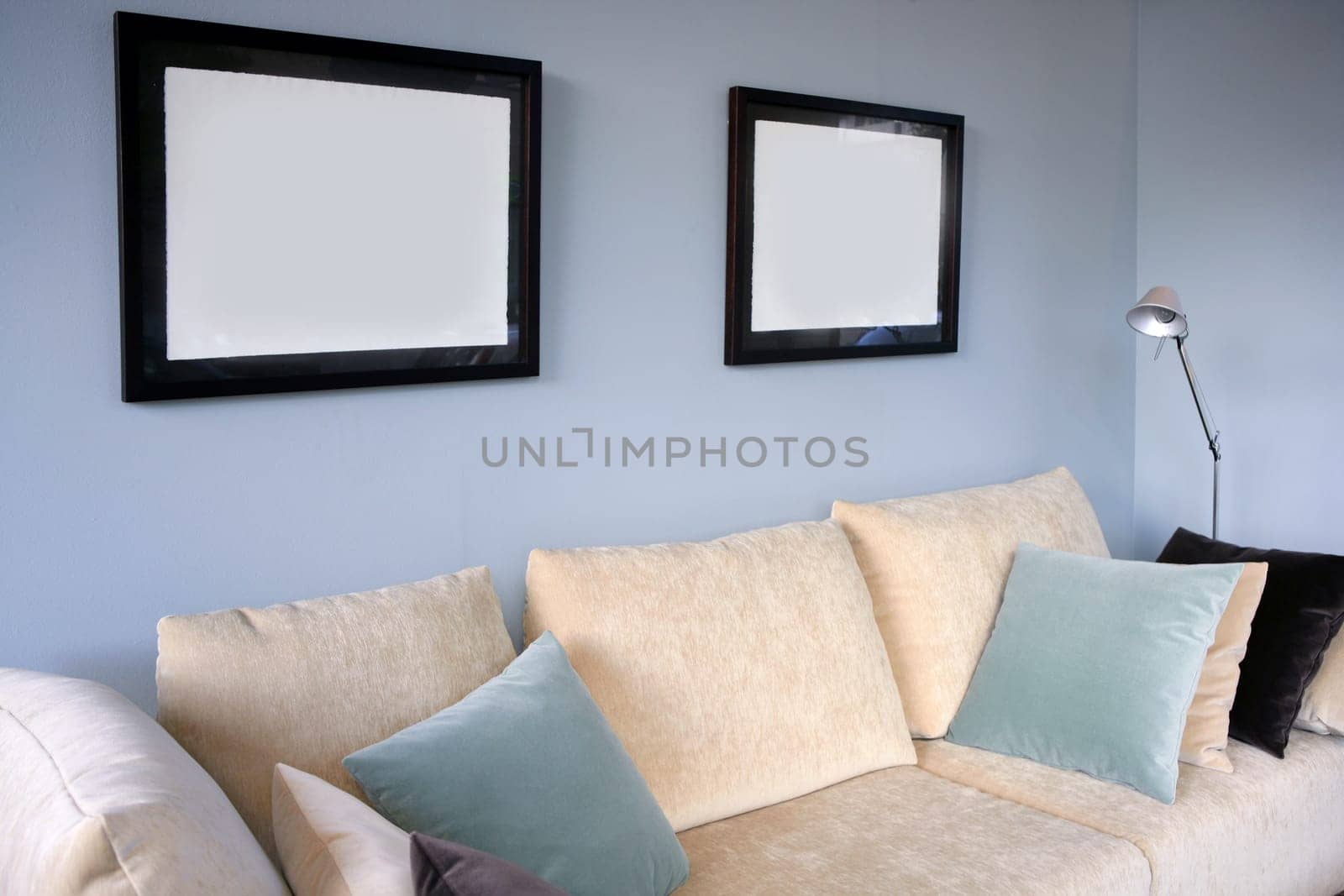 Living room with cream sofa, soft blue wall, interior design