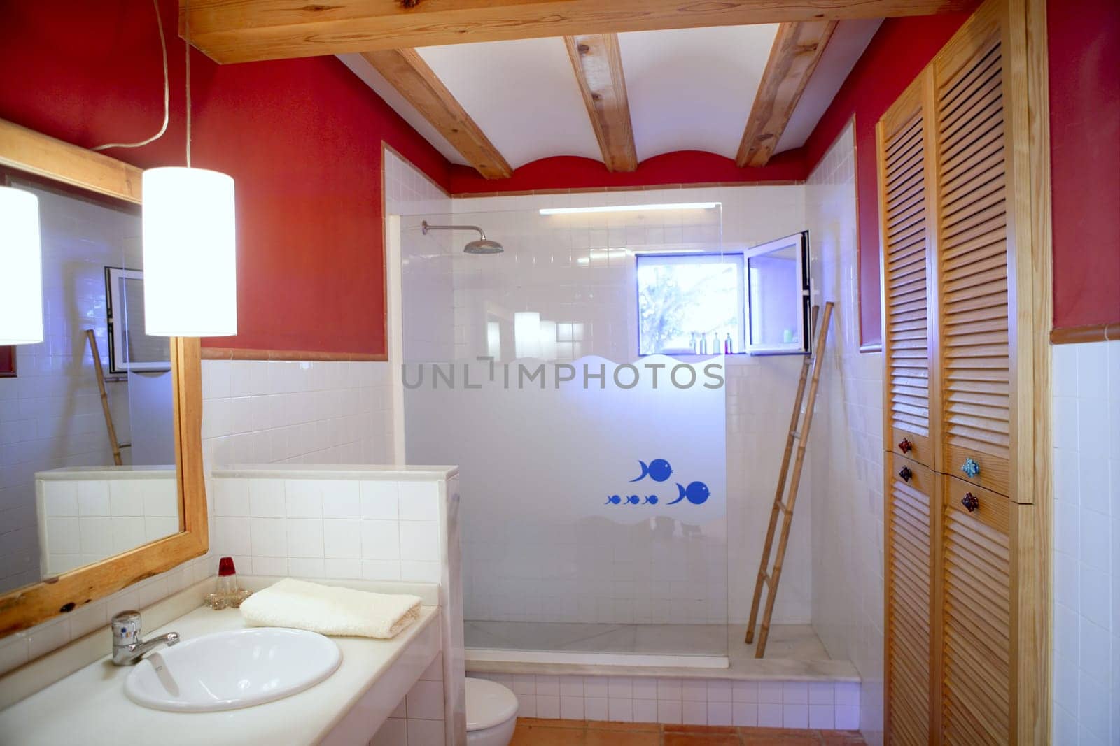 Nice warm white bathroom, red walls natural light interior