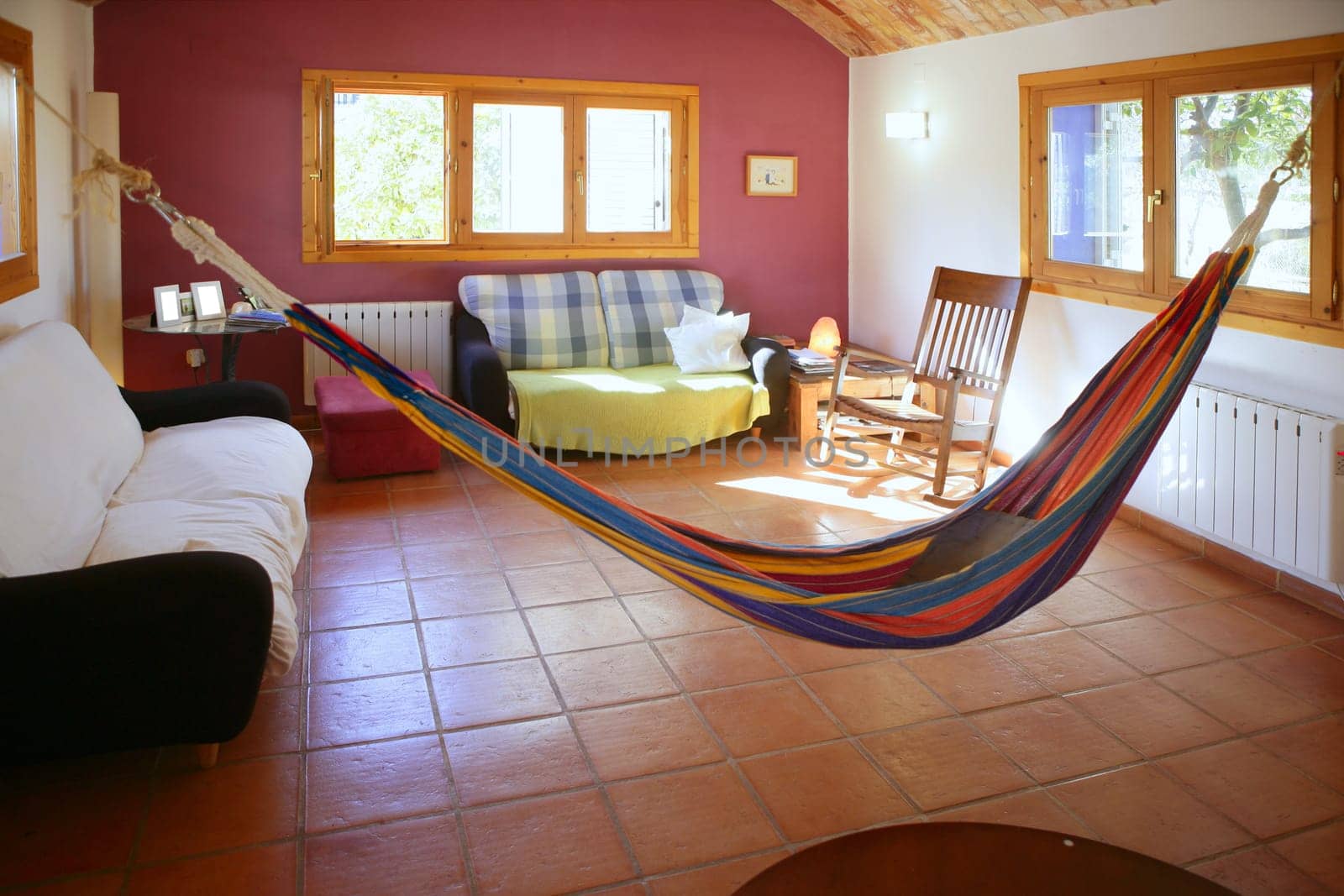 Nice living room with colorful hanged mexican hammock in Spain