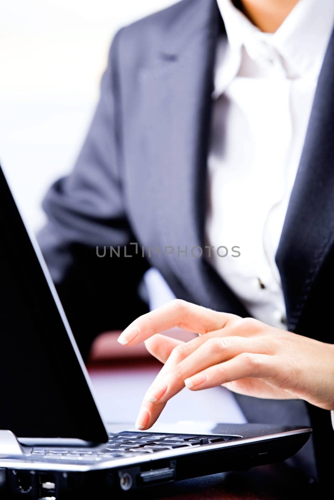 Magnified photo of business woman pushing button of laptop