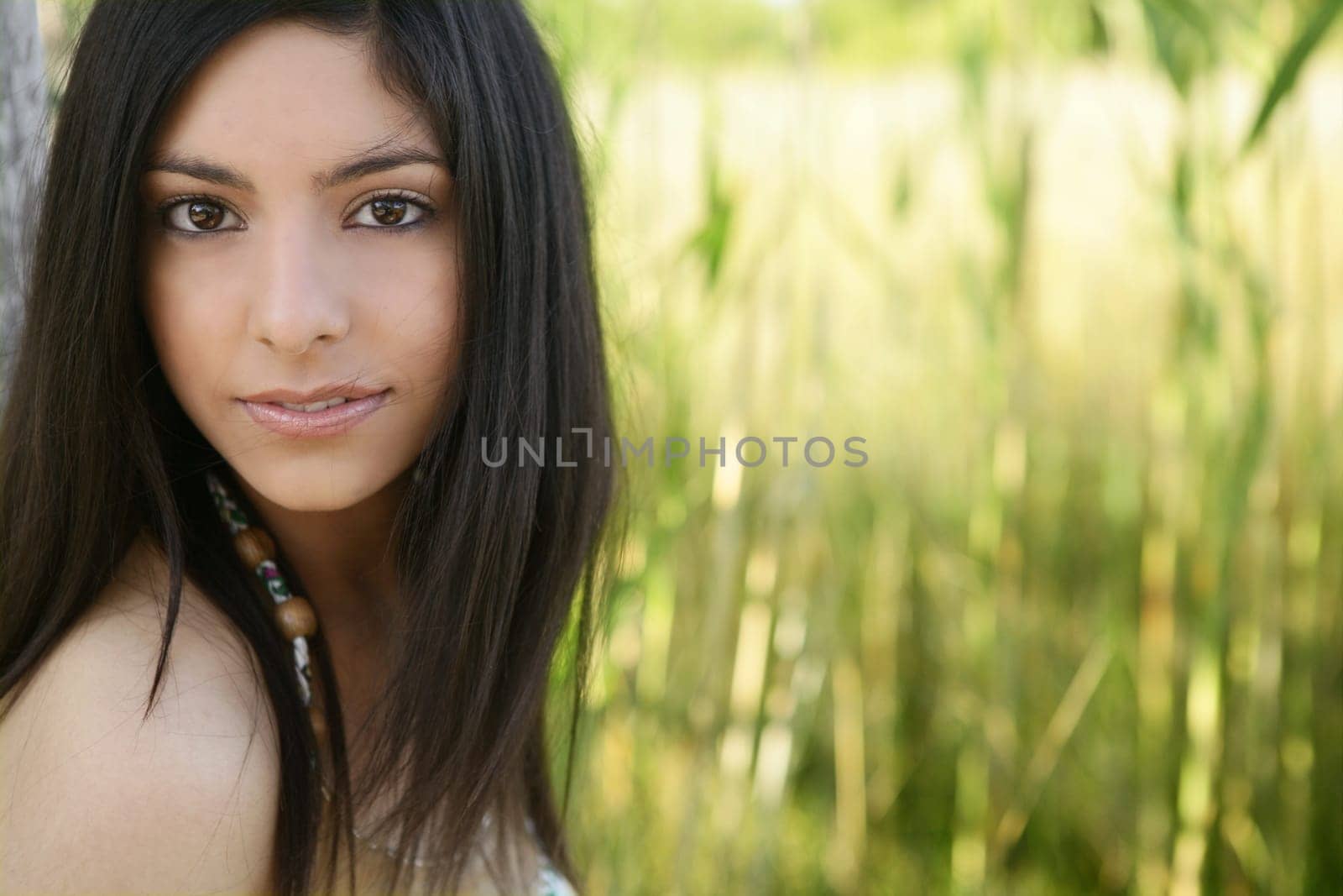Portrait of beautiful indian woman on nature, cane field