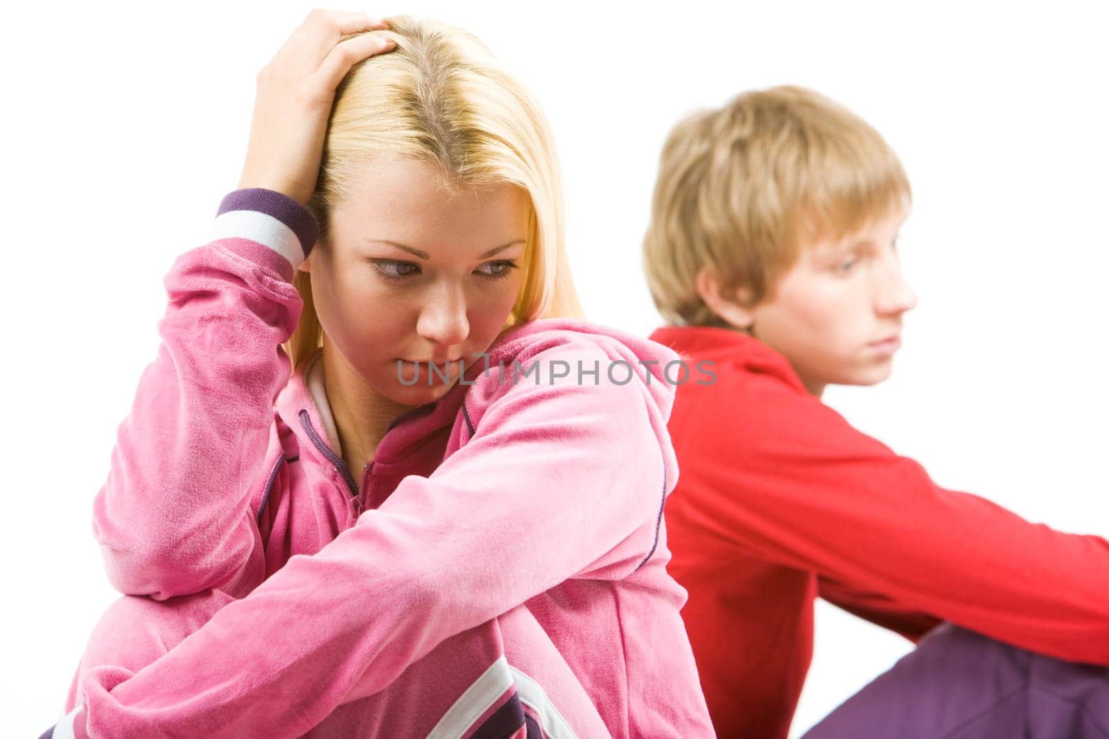 Image of sad girl with troubled guy at background after having an argument