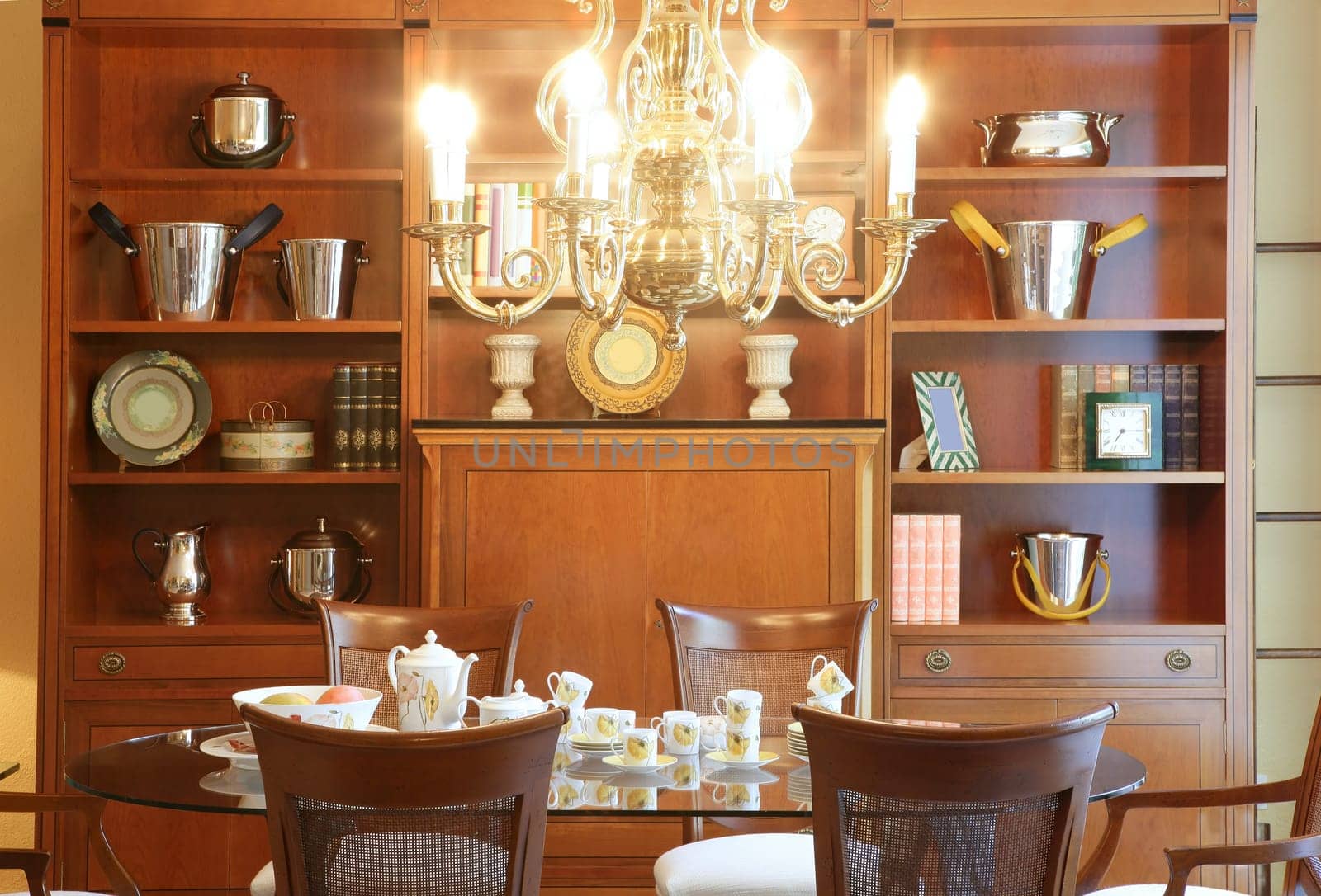 Classic living room table library furniture glowing chandelier warm wood
