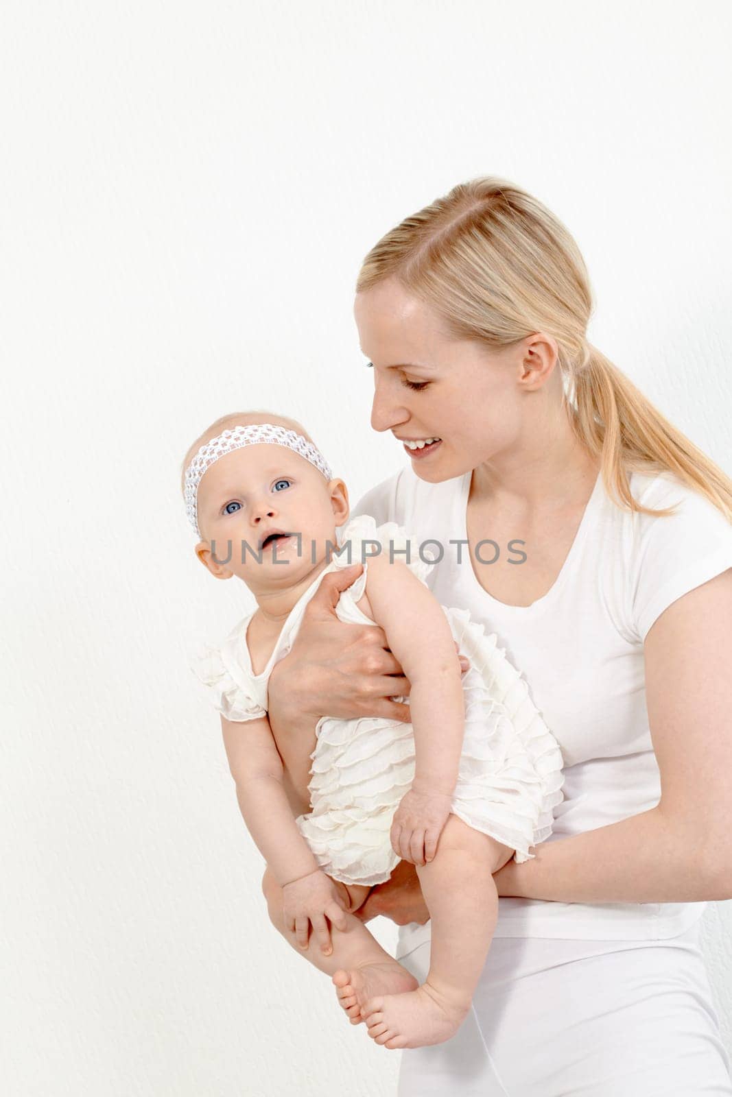 Portrait of happy woman holding her small daughter