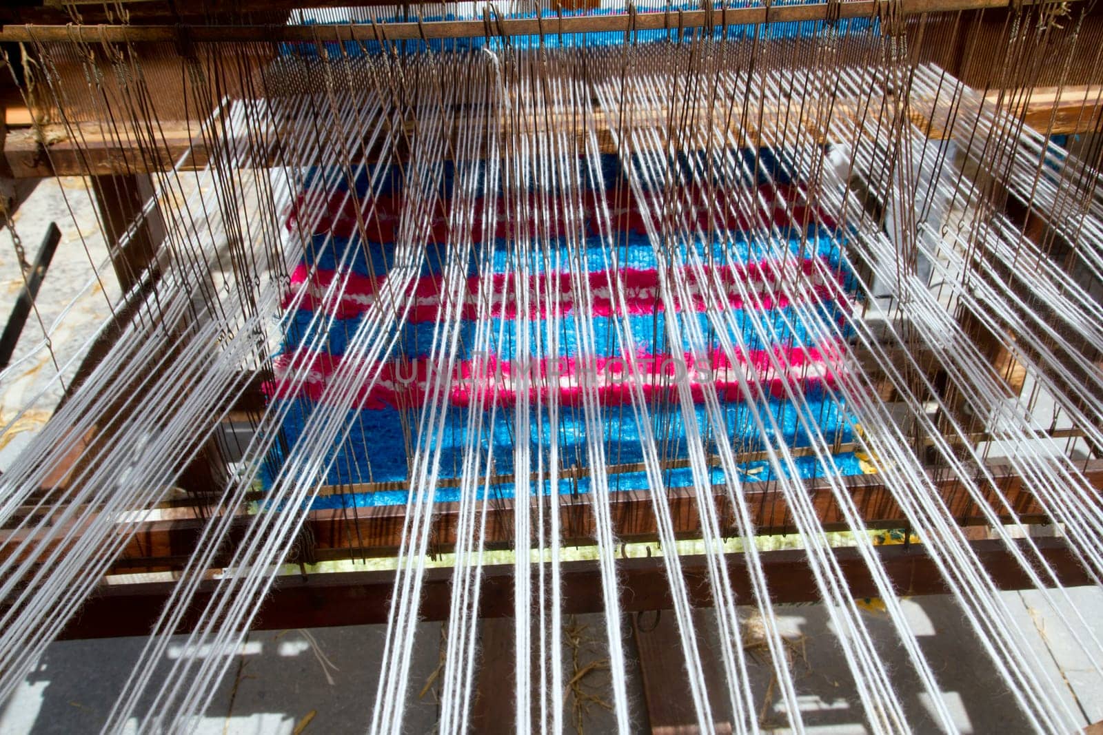 antique vintage spinner machine working in mediterranean fabric