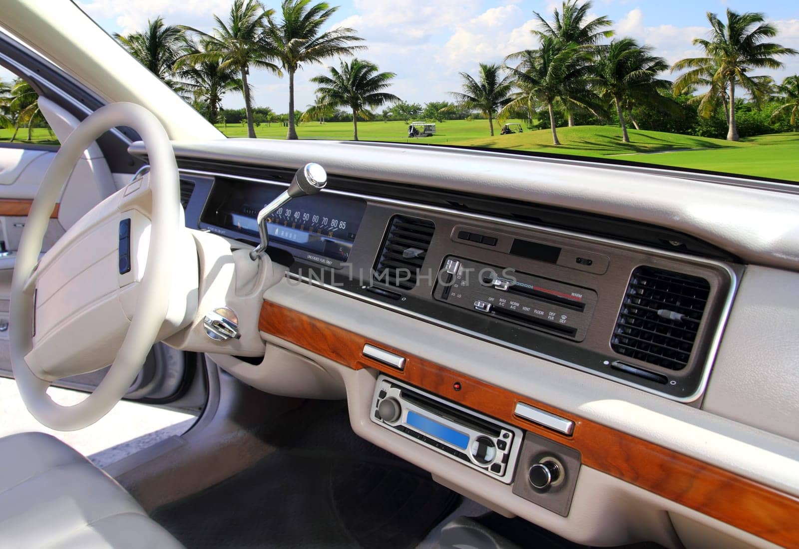 retro vintage car indoor with Caribbean golf course in window view