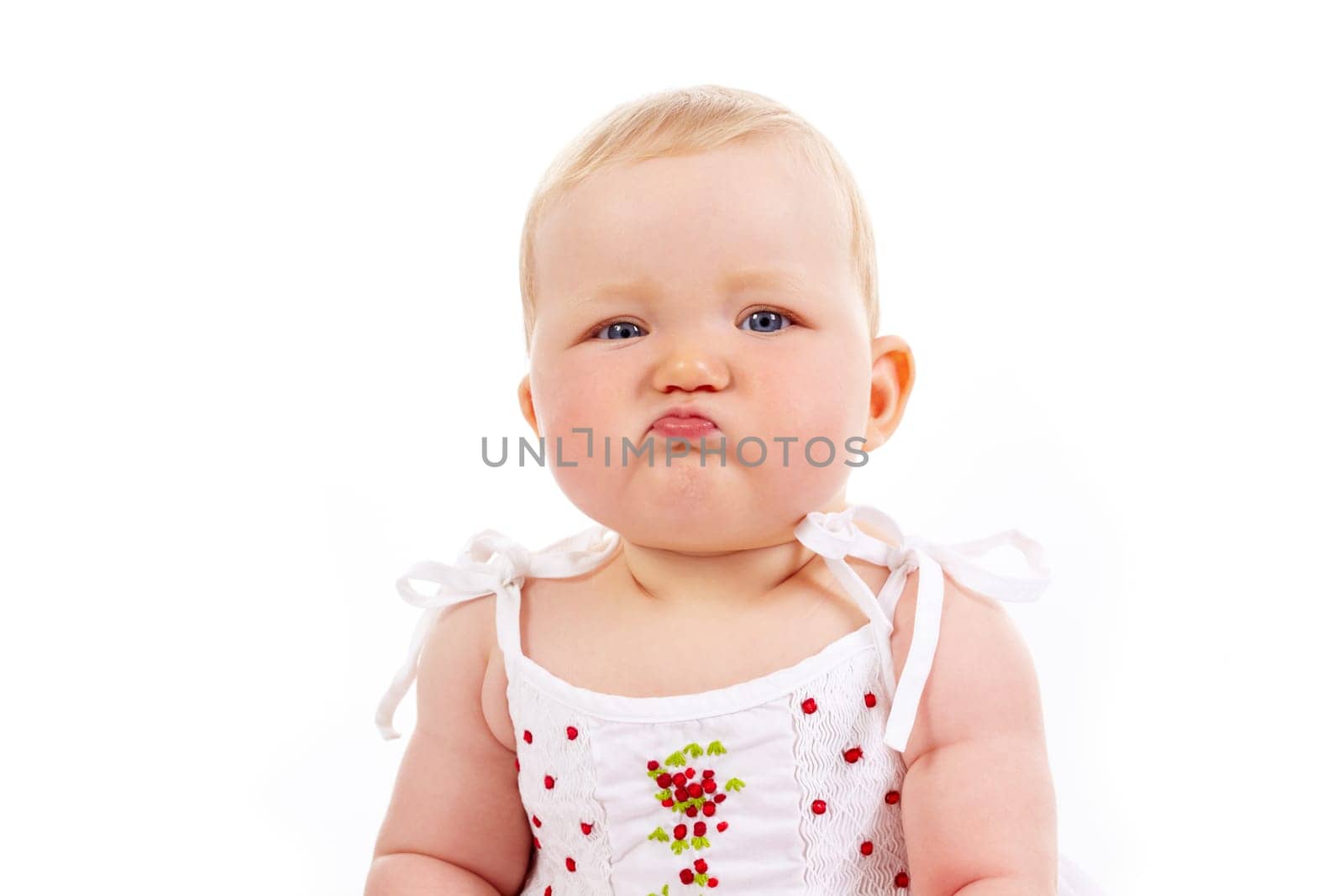 Portrait of small girl with capricious expression looking at camera