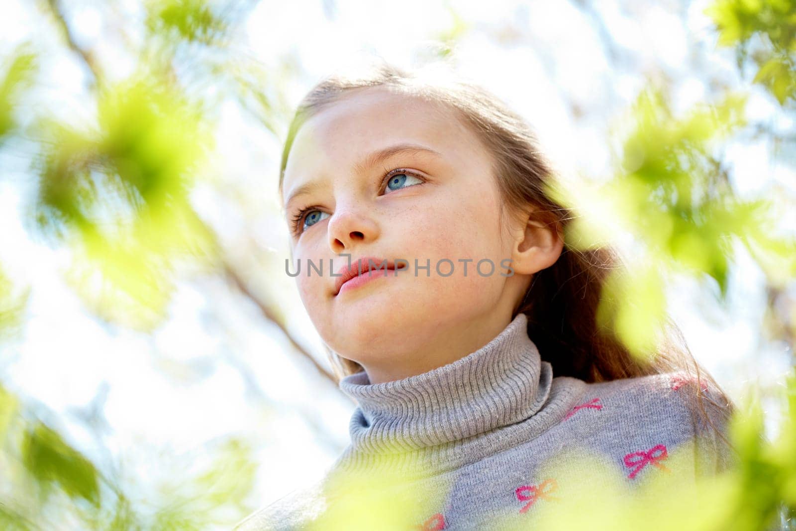 Portrait of calm girl looking upwards in natural environment