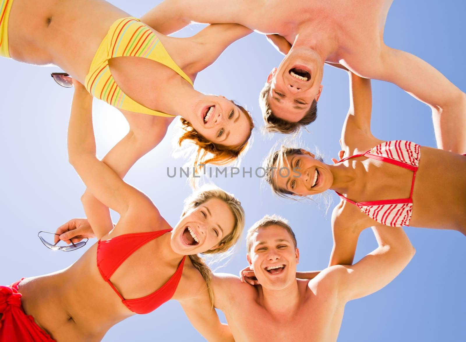 Image of five teens touching each other's back by hands
