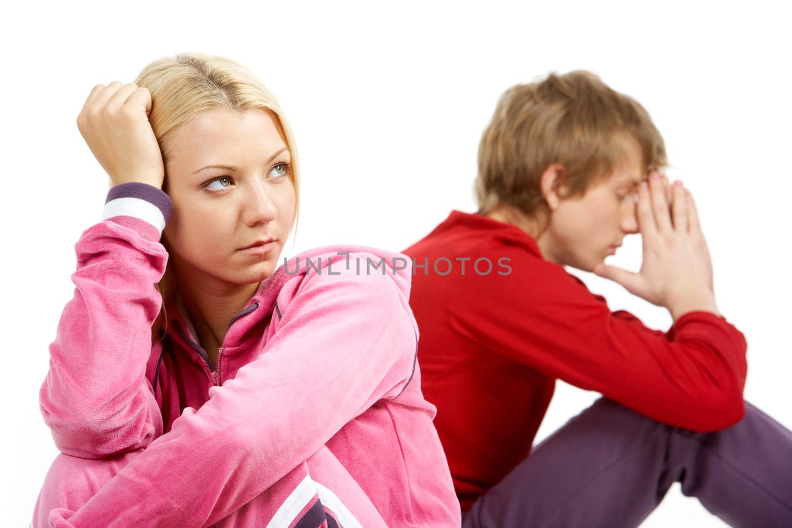 Image of sad girl with confused guy at background after having an argument