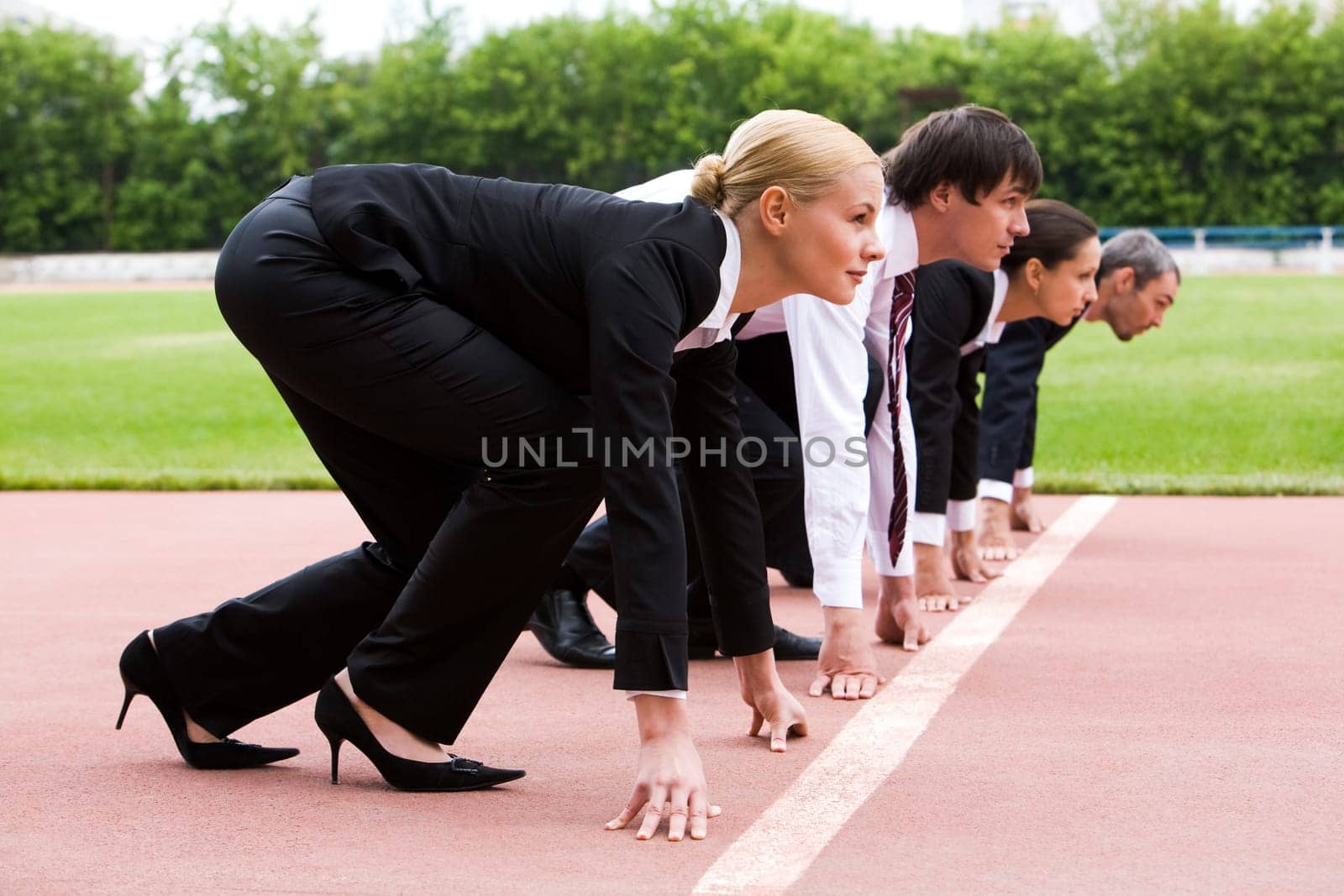 Row of business people getting ready for race