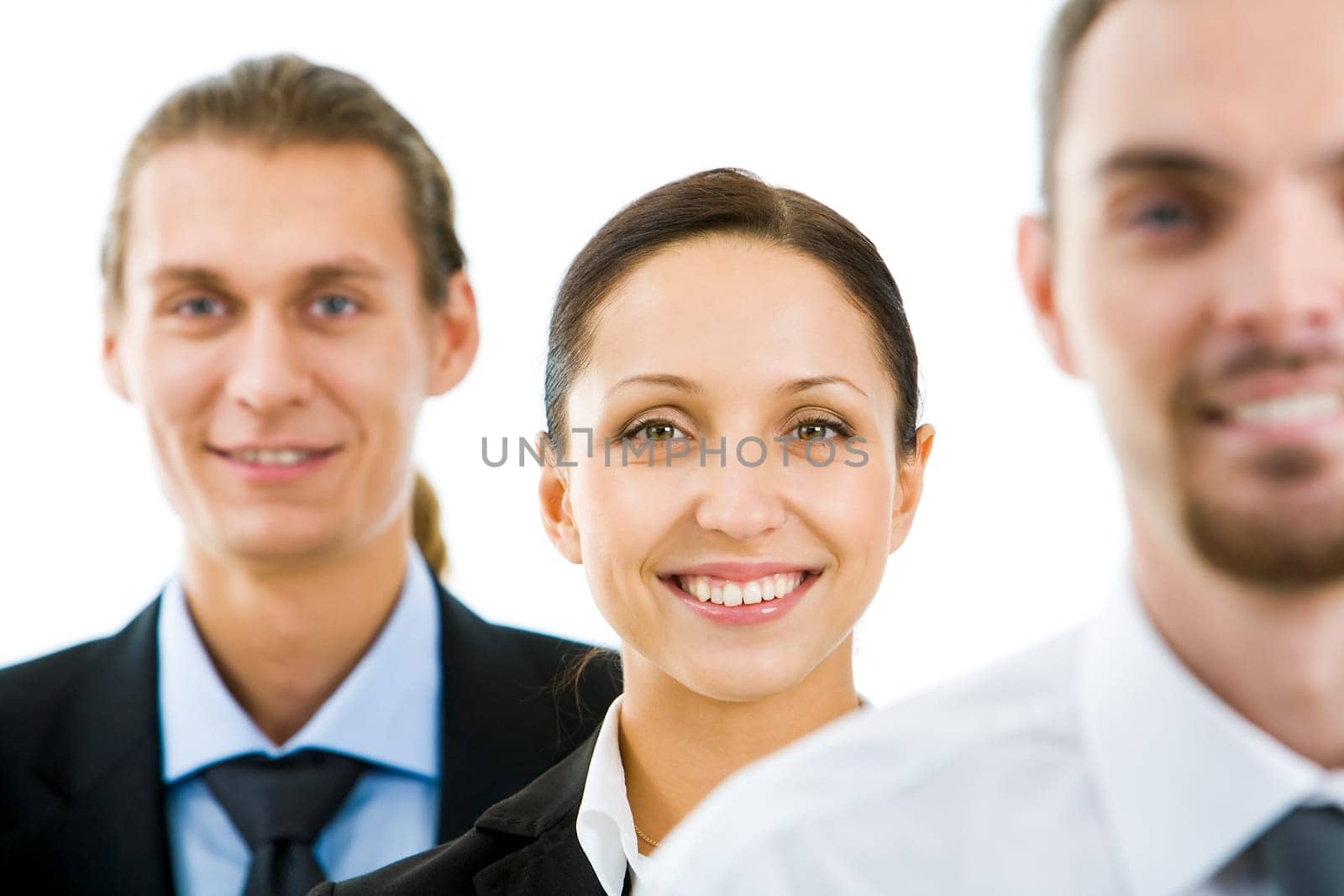 Portrait of happy businesswoman smiling at camera with colleagues