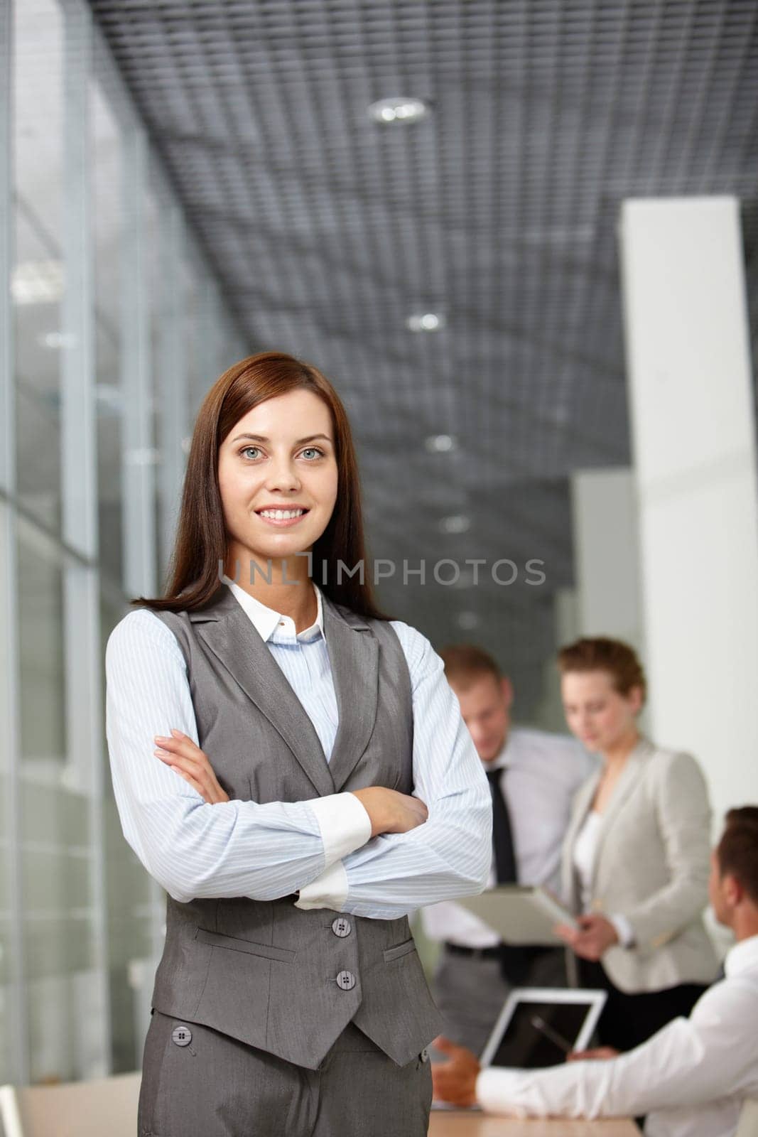 A beautiful businesswoman looking at camera in working environment
