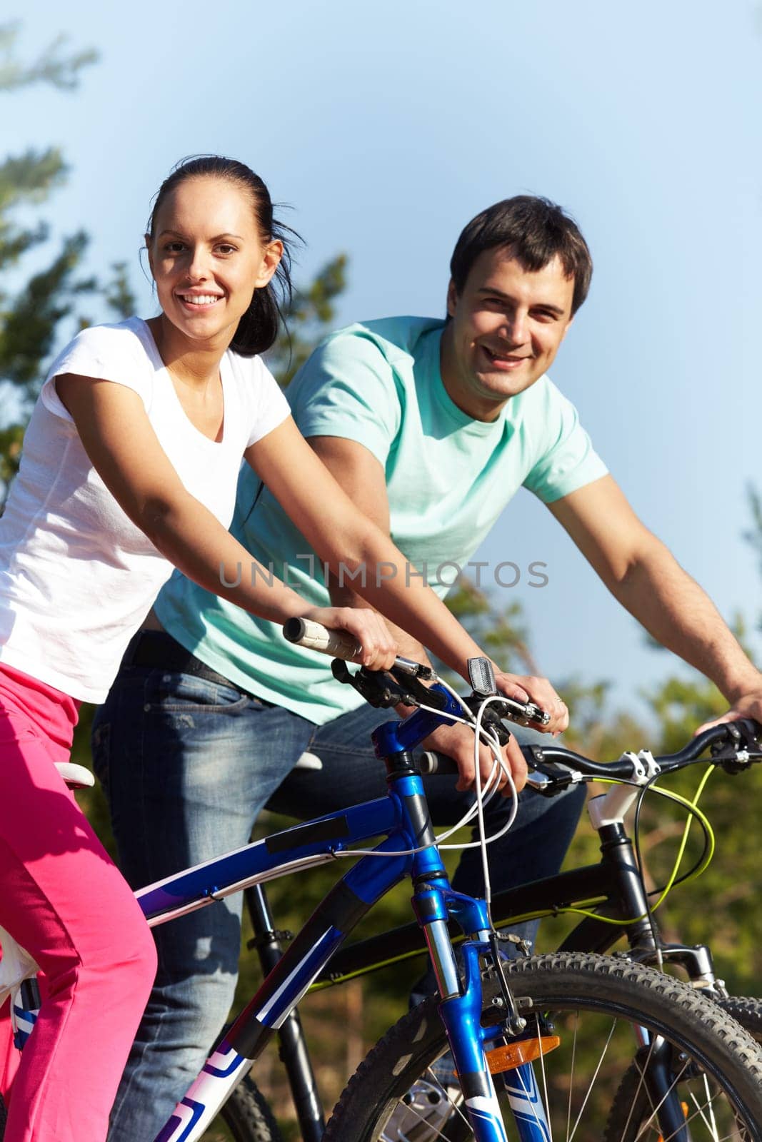 Portrait of two young people on bikes