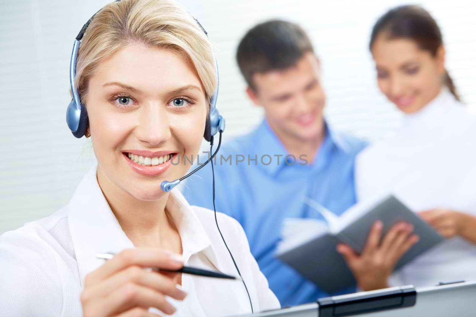Face of pretty secretary wearing headset in working environment