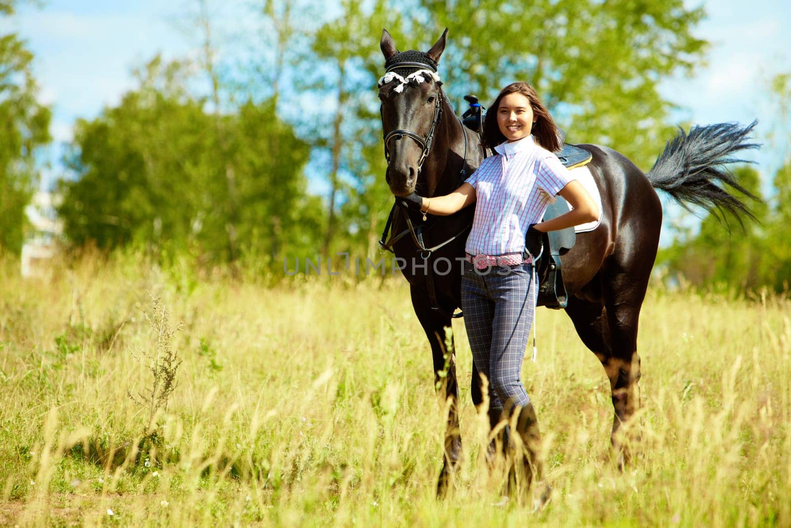 Image of happy female with purebred horse outdoors