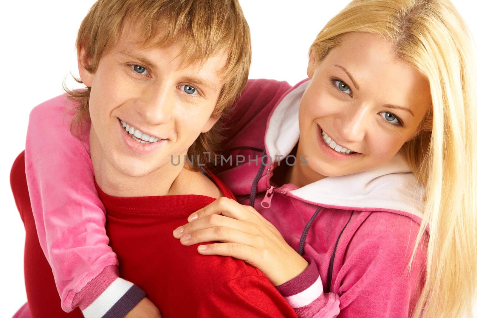 Portrait of happy guy being hugged by his pretty girlfriend