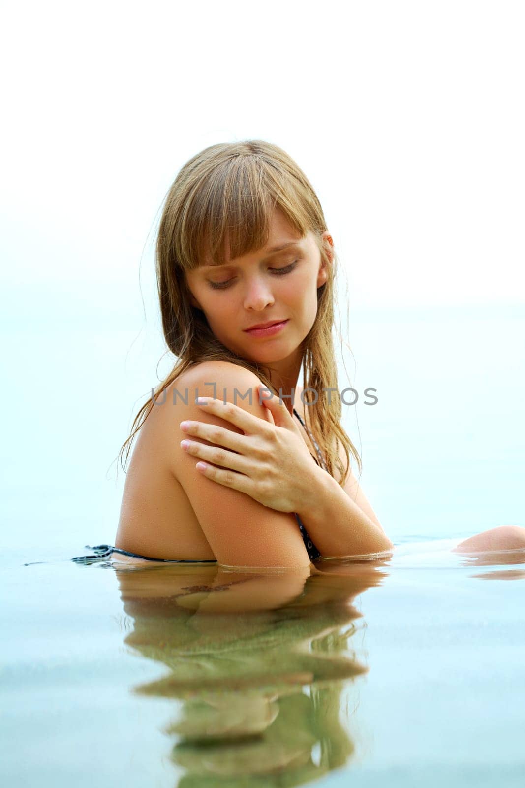 Portrait of fresh young girl in water
