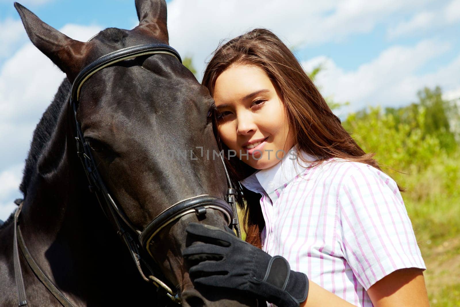 Image of happy female with purebred horse near by