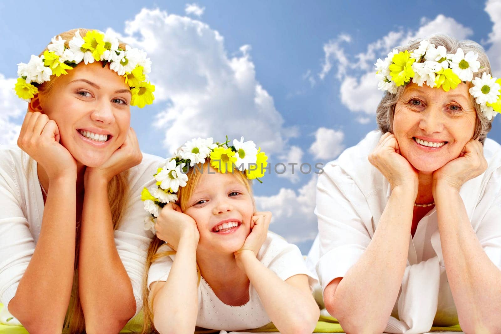 Portrait of grandmother, mother, grandchild with diadems lying in the studio