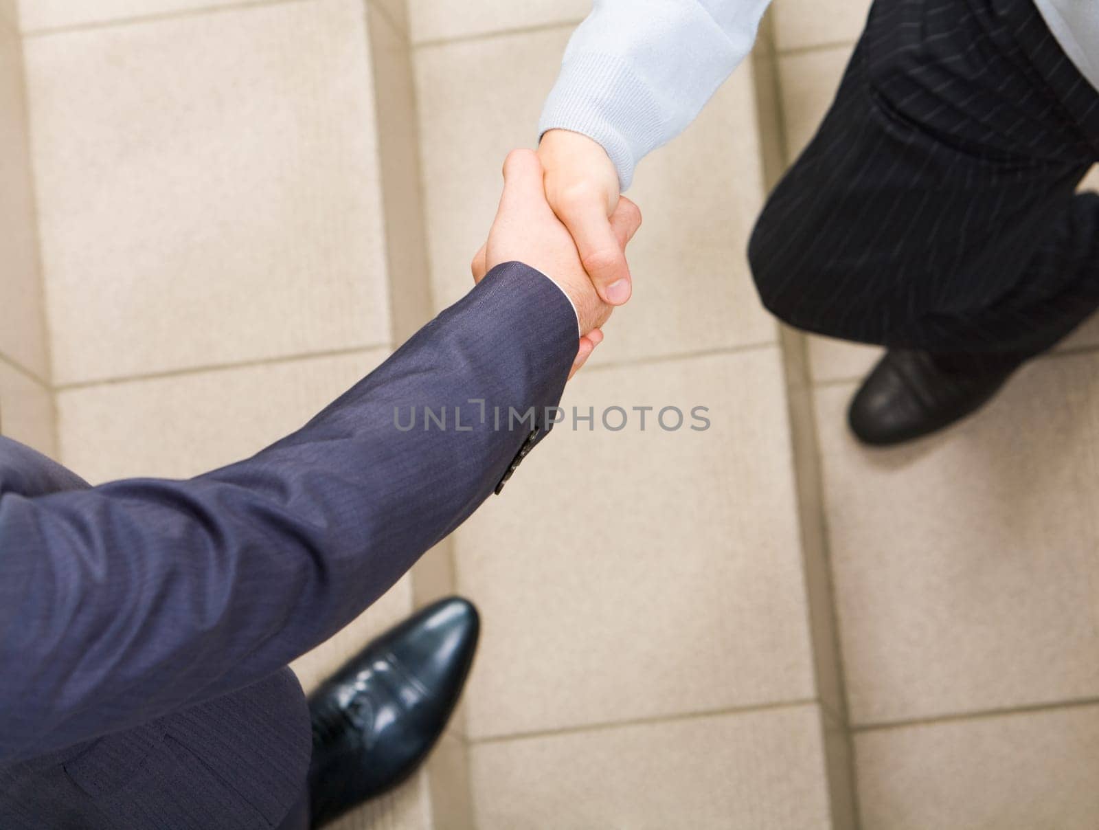 Photo of handshake of businessmen on staircase