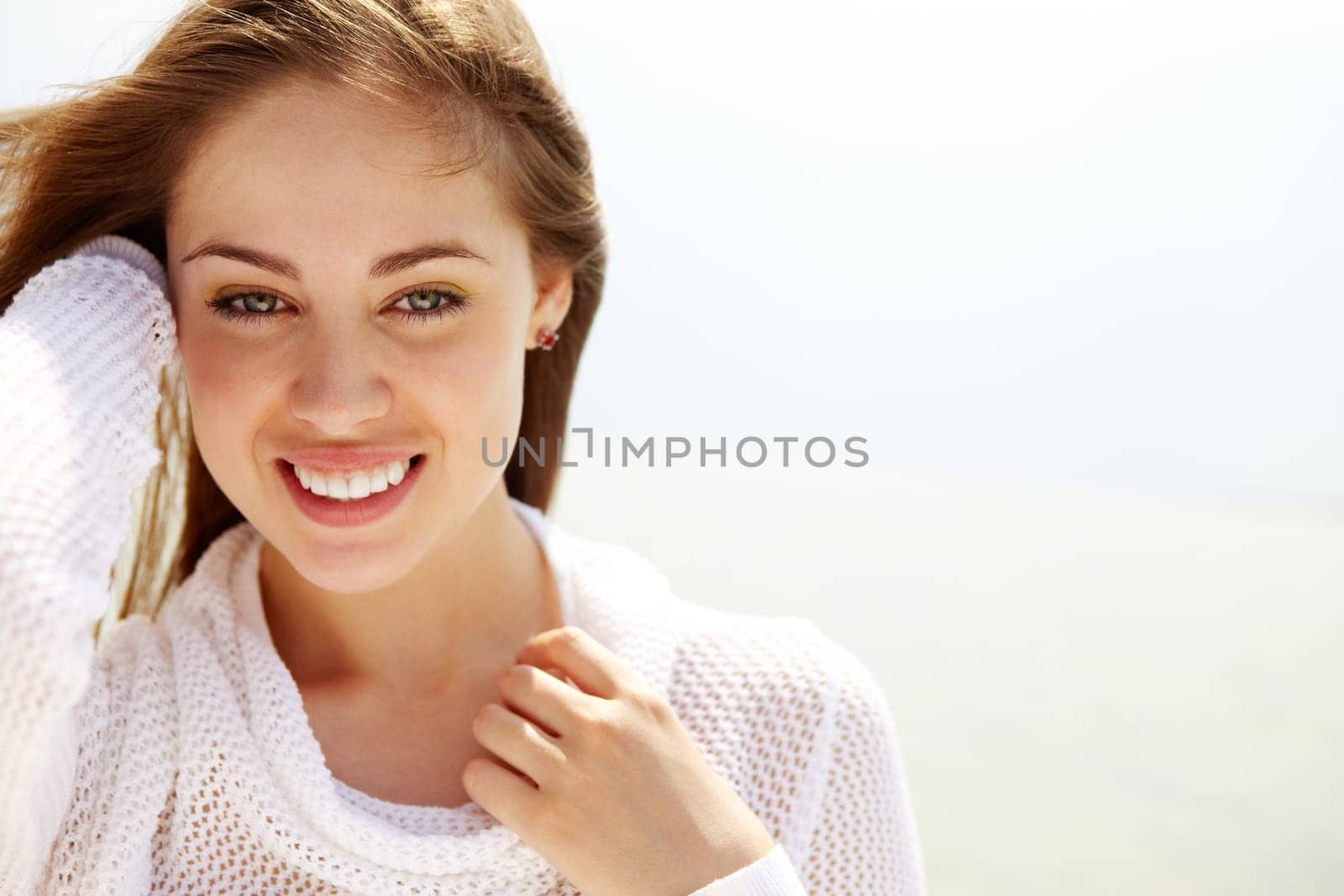 Image of happy female looking at camera on summer day