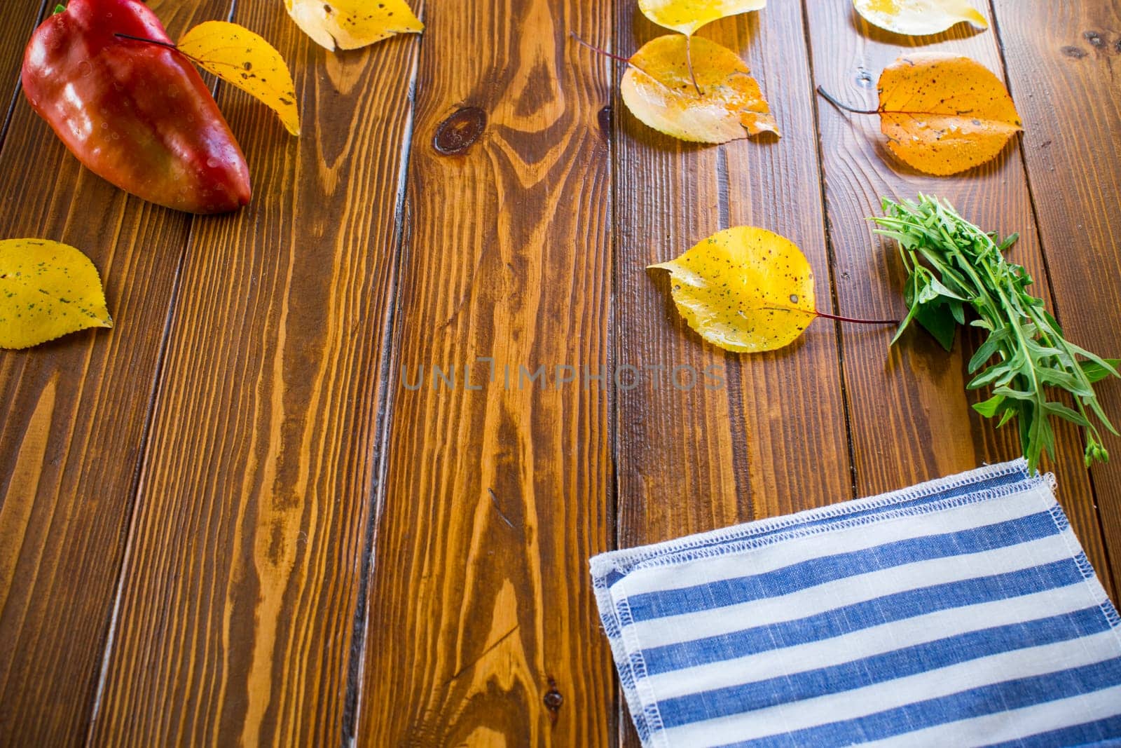 wooden background with empty clean space in the center, autumn foliage. by Rawlik