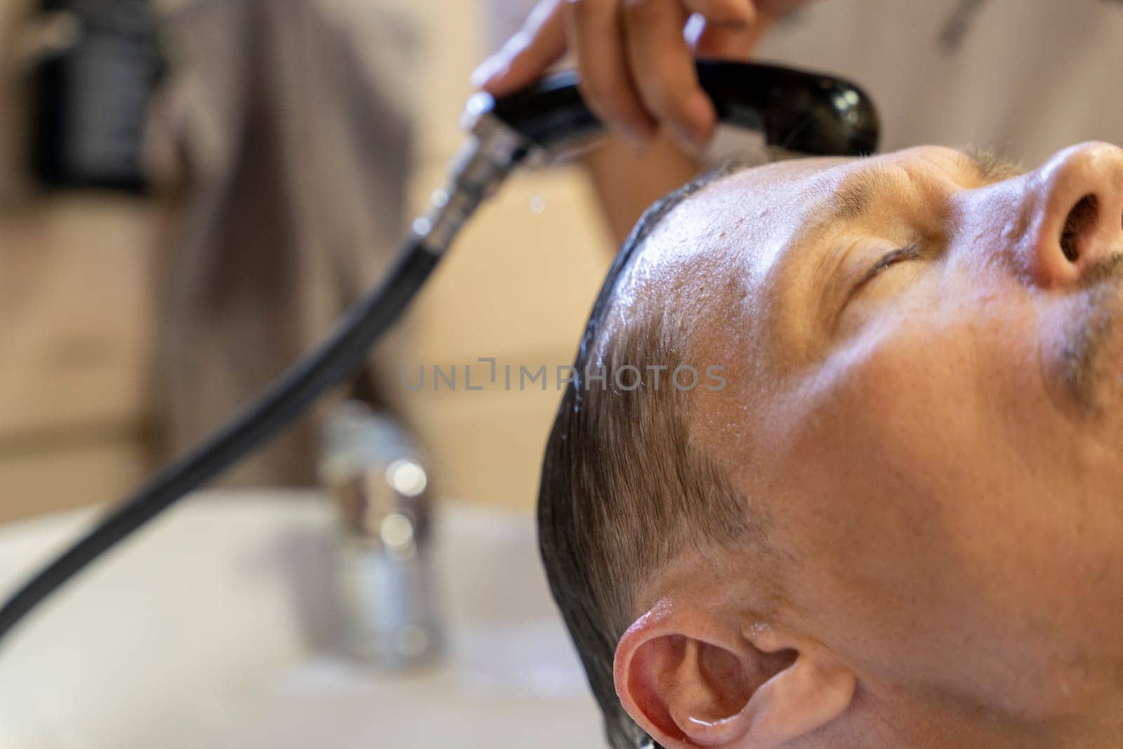 man washes his hair while visiting a hairdresser by audiznam2609