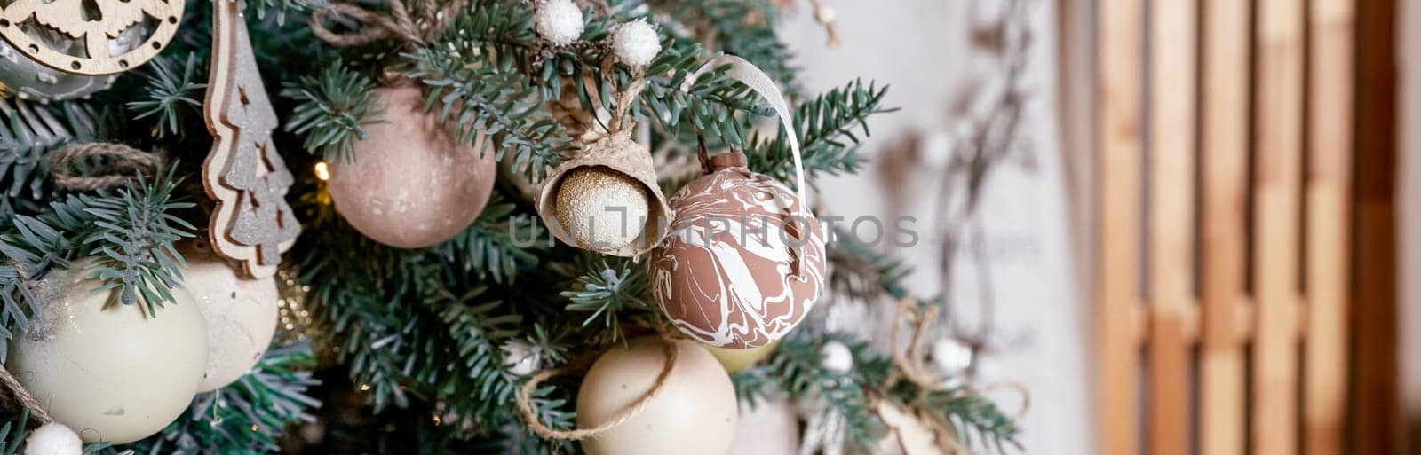 Diy honeycomb paper christmas ornaments hanging from Christmas tree by a window