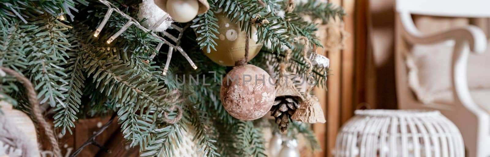 Diy wooden, paper christmas ornaments hanging from Christmas tree.Festive winter holidays background