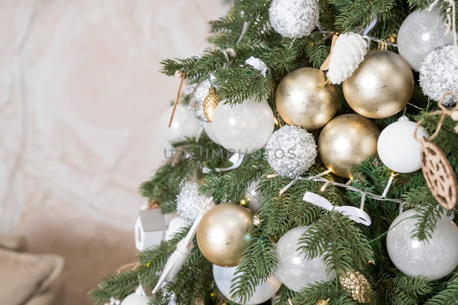 Photo of luxury gift boxes under Christmas tree, New Year home decorations, golden wrapping of Santa presents