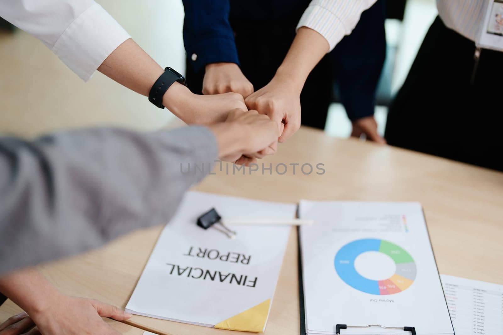 business group people showing unity with their hands together by Manastrong