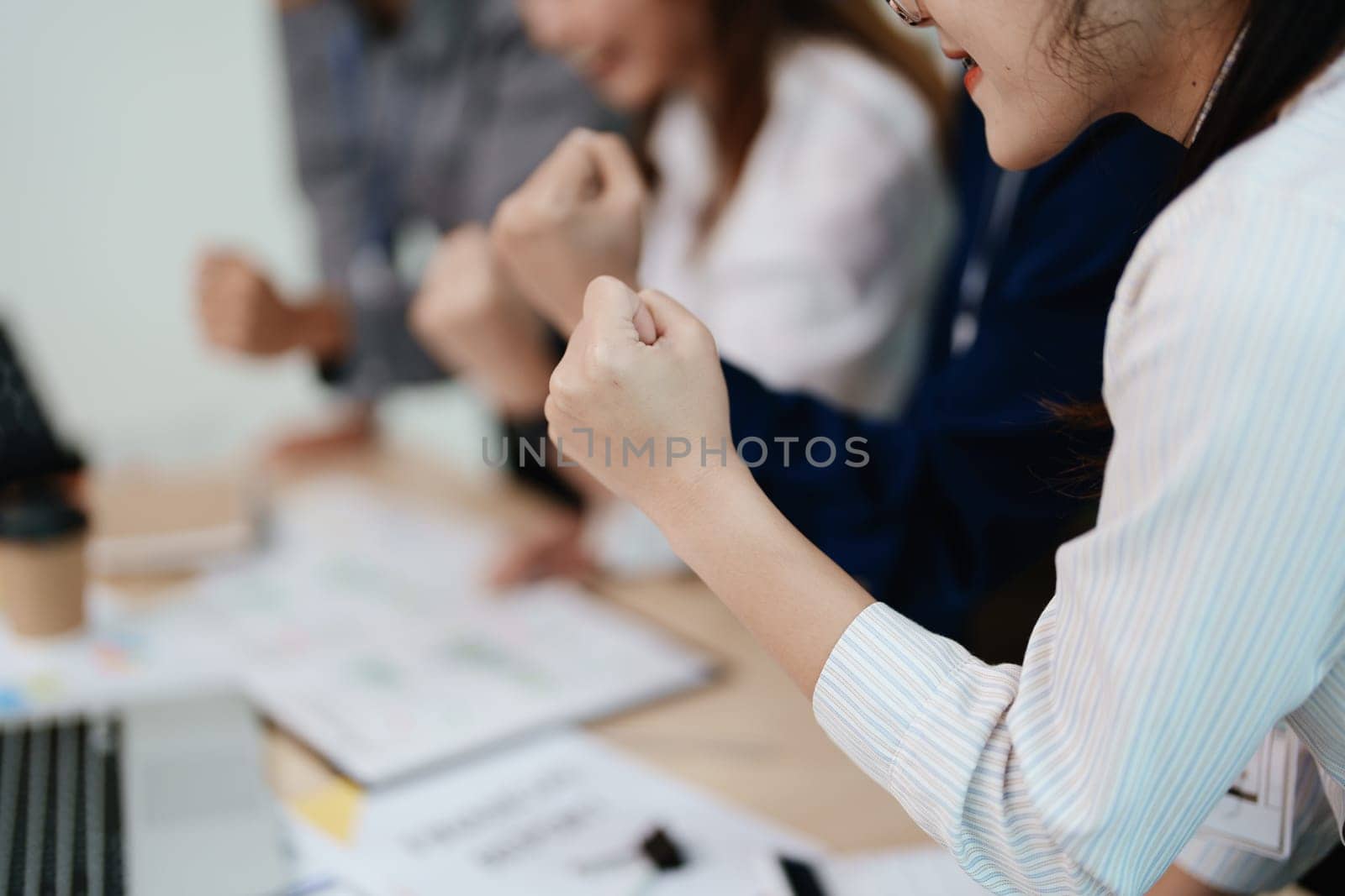 business group people showing unity with their hands together by Manastrong