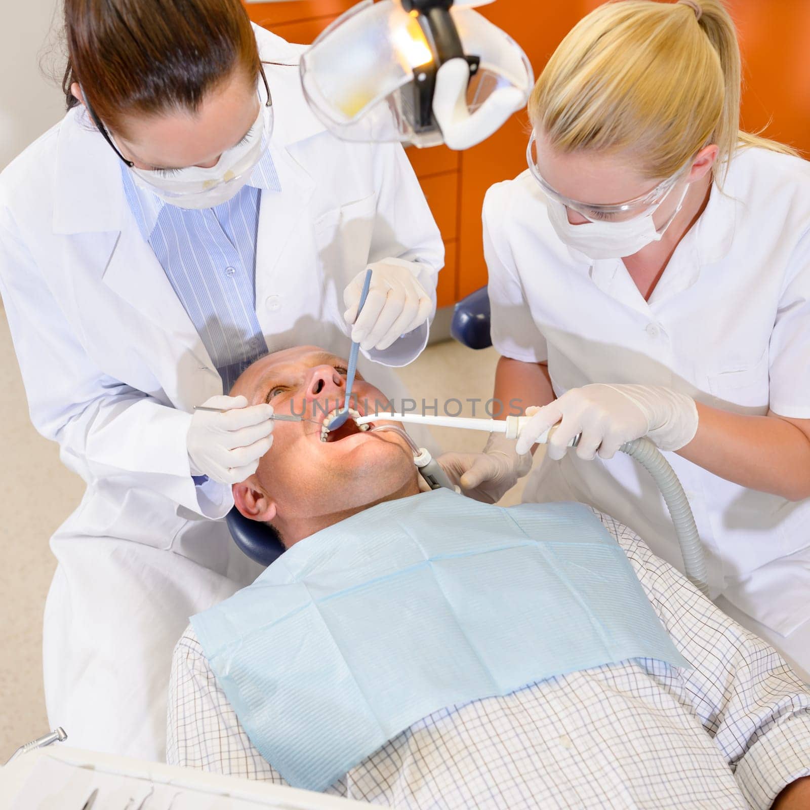 Male patient having dental checkup at surgery stomatology clinic