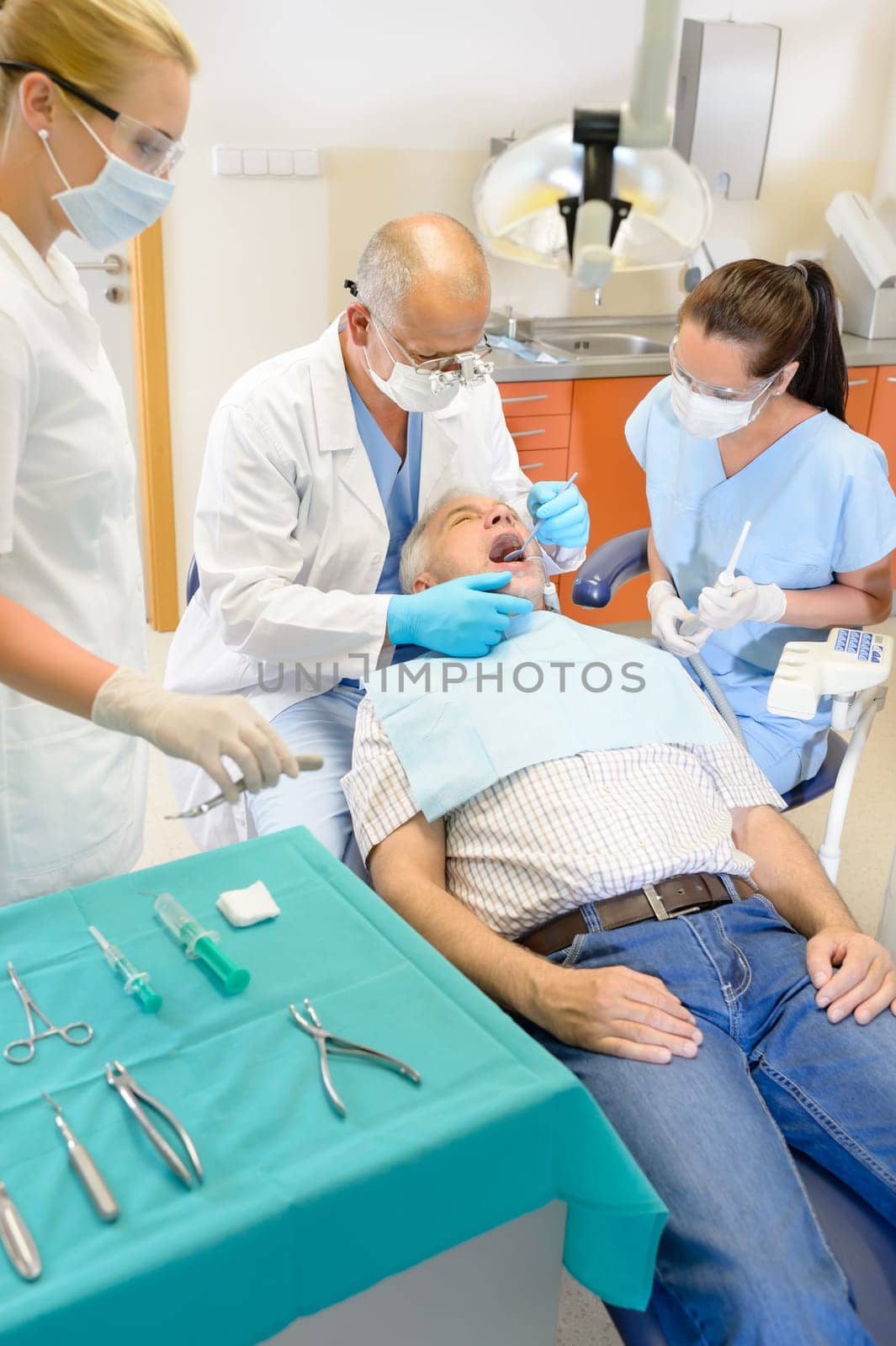 Senior man at dentist surgery having tooth operation stomatology clinic