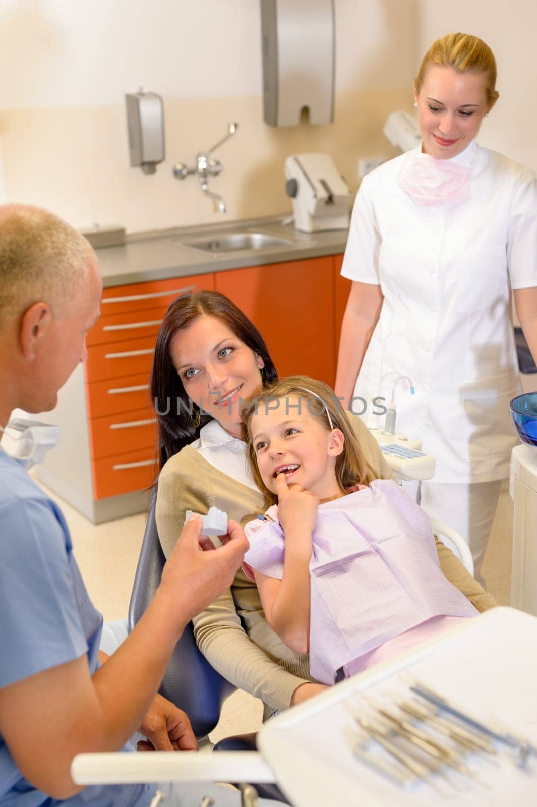 Little girl visit dentist surgery show teeth to stomatology specialist