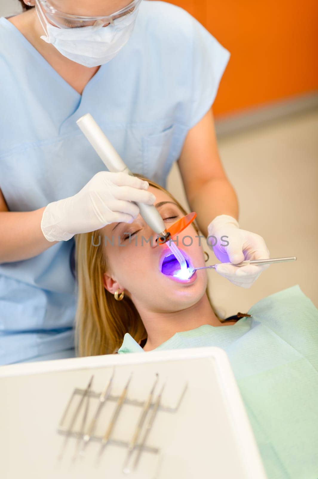 Young woman having dental surgery in stomatology clinic teeth checkup