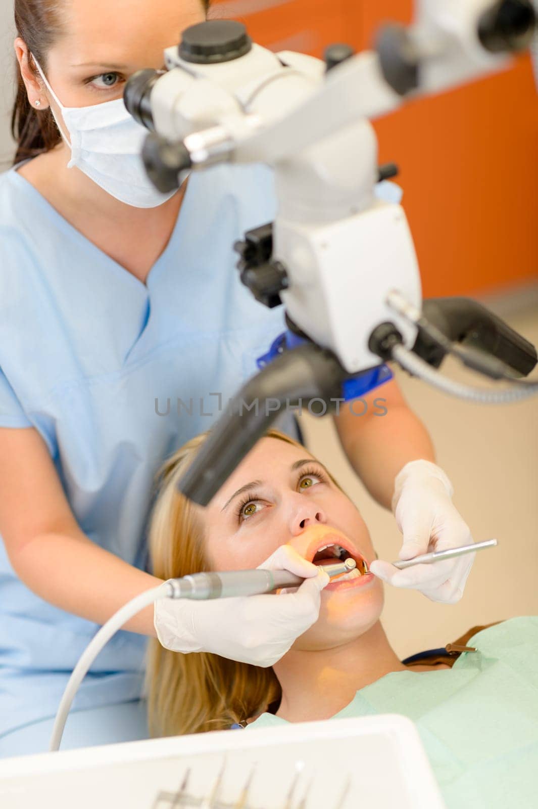 Young woman having dental surgery in stomatology clinic teeth checkup